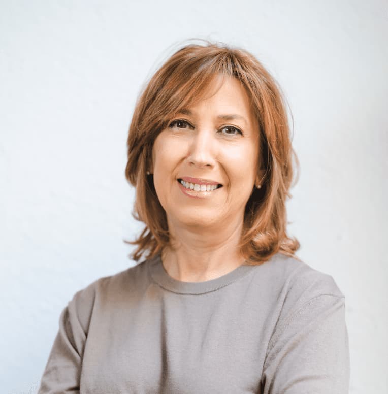 Mujer de mediana edad, cabello castaño claro y sonrisa cálida, representa con confianza a en Madrid